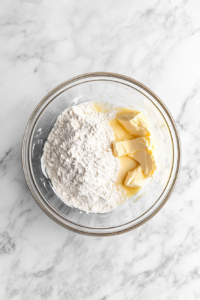 combining-dry-and-wet-ingredients-in-glass-bowl-on-marble