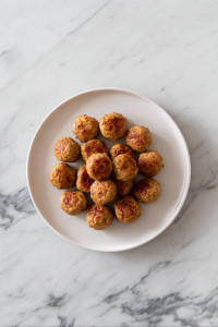 cooked-greek-meatballs-resting-on-white-plate