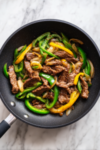 cooking-steak-and-softening-vegetables-in-skillet