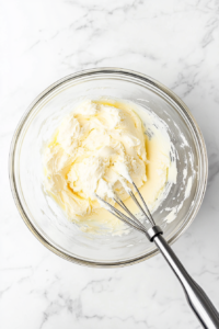 cream-cheese-butter-sugar-mixture-in-glass-bowl-for-banana-split-cake