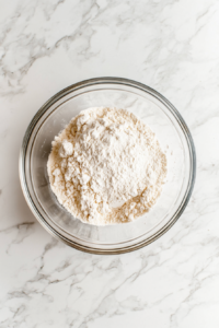 dry-ingredients-flour-baking-powder-salt-in-glass-bowl