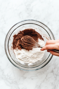 flour-cocoa-baking-powder-salt-mixed-in-glass-bowl-on-white-marble-2