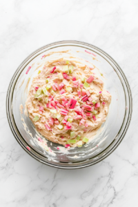 folding-diced-rhubarb-into-cake-batter-in-glass-bowl