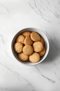 freshly-baked-lancashire-biscuits-served-in-white-ceramic-bowl-on-white-marble-countertop