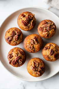 freshly-baked-pecan-muffins-in-pan-on-white-marble-2