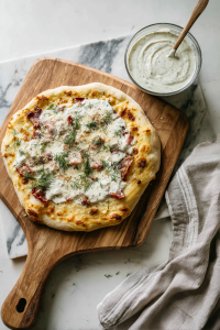 garlic-dill-sauce-spread-on-dough-marble-surface
