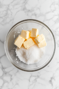 glass-bowl-with-butter-yeast-sugar-salt-and-warm-water-on-marble