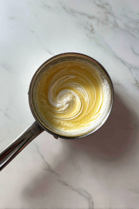 glaze-with-cream-in-saucepan-on-marble