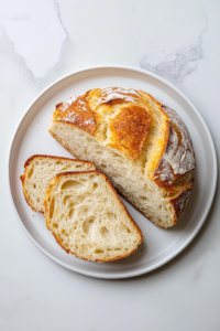 golden-brown-no-oven-bread-in-black-dutch-oven-on-marble-cookto