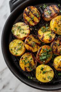 grilled-potatoes-seasoned-with-fresh-herbs-on-white-marble