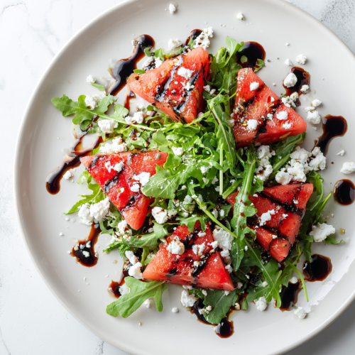 grilled-watermelon-salad-on-white-marble-arugula-cheese-feta