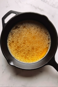 heating-olive-oil-in-black-skillet-for-greek-meatballs