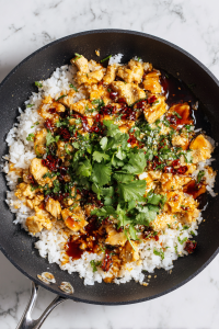 herbs-and-seasonings-added-to-pineapple-chicken-rice-mixture