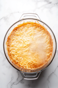 large-glass-pot-with-boiling-water-lasagna-noodles-white-marble