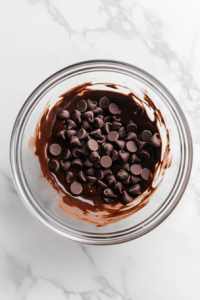 melting-chocolate-chips-and-butter-in-glass-bowl-white-marble