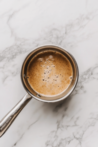melting-chocolate-in-coffee-and-milk-mixture-on-white-marble