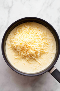 melting-shredded-cheese-into-creamy-broth-mixture