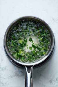 mint-syrup-simmering-in-saucepan-with-bubbling-sugar-and-mint