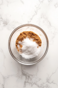 mixing-cinnamon-and-sugar-in-glass-bowl-on-marble