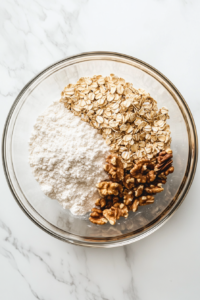 mixing-crust-oats-flour-sugar-glass-bowl-white-marble