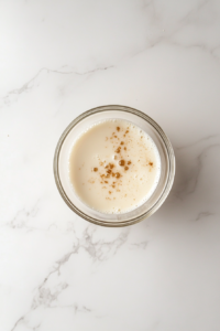 mixing-few-drops-of-vanilla-flavor-in-the-bowl-of-milk-for-enhanced-flavor