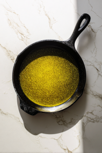 neutral-oil-heating-in-black-cast-iron-skillet