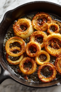 onions-golden-browning-in-black-skillet-white-marble-clean-photo