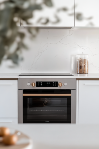 This image shows a clean digital oven display set to 350°F above a white marble cooktop, indicating preheating before baking mini cookies.