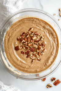 pecans-folded-into-pound-cake-batter-in-glass-bowl