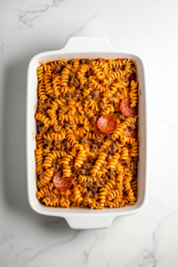 pizza-casserole-mixture-transferred-to-ceramic-baking-dish