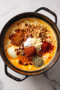 pouring-stock-coconut-milk-and-spices-into-rice-mixture-2