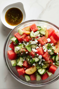 pouring-vinaigrette-over-peach-watermelon-salad