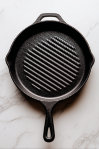 preheated-black-cast-iron-grill-pan-on-white-marble-top
