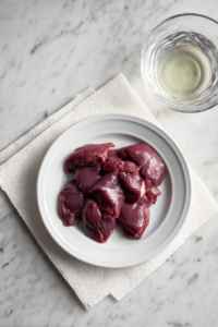 prepped-chicken-livers-on-white-plate-glass-bowl-prep-shot