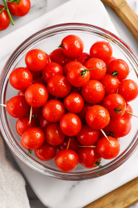 pricking-cherry-tomatoes-in-glass-bowl-with-toothpick-for-pickling