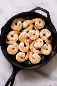 raw-shrimp-seasoning-in-black-skillet