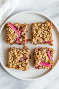 served-rhubarb-oat-bars-white-plate-marble-countertop