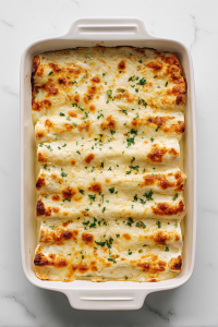 serving-white-chicken-enchiladas-on-white-plate-with-sides-2