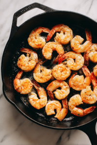 shrimp-turning-pink-in-black-skillet