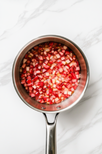 simmering-rhubarb-filling-saucepan-white-marble-cooktop