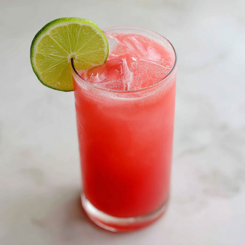 single-glass-of-watermelon-agua-fresca-with-lime-on-white-marble