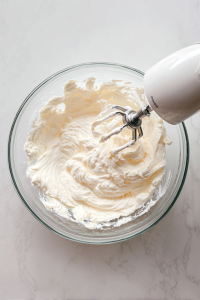 smooth-pourable-cream-cheese-frosting-in-glass-bowl