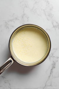 smooth-thickened-milk-mixture-in-small-glass-saucepan
