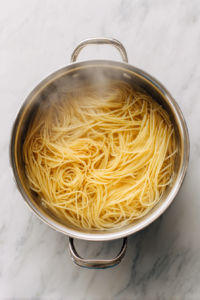 spaghetti-cooking-in-boiling-water-inside-silver-pot