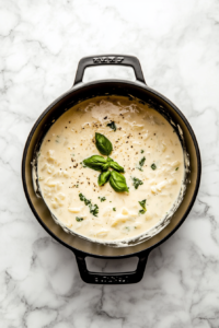 spinach-chicken-cream-cheese-added-to-marry-me-soup-in-black-dutch-oven