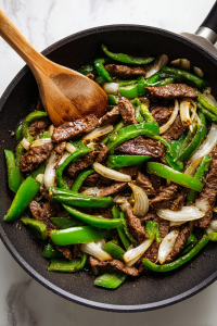 steak-veggies-mixed-in-black-cast-iron-skillet