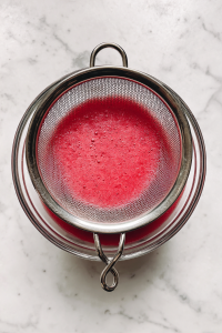 straining-watermelon-puree-through-mesh-sieve