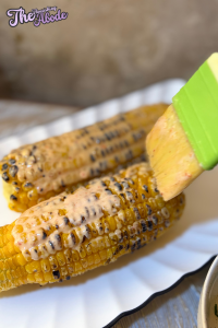 use a brush to generously coat one cob with the mayo mixture
