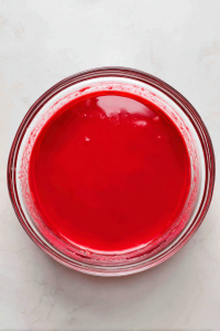 vibrant-red-batter-with-food-coloring-in-glass-bowl-on-marble