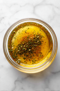 whisked-shrimp-marinade-in-glass-bowl-on-white-marble